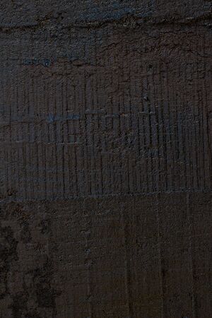 Black resin wall texture with scratches and cracks.の写真素材