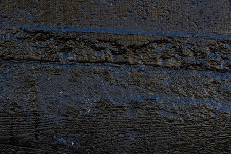 Black resin wall texture with scratches and cracks.の写真素材