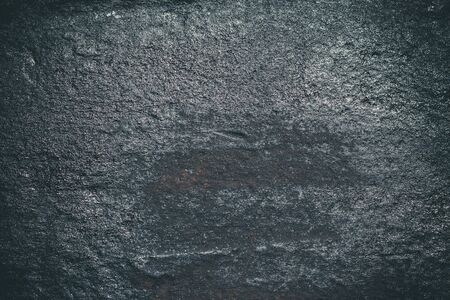 Black resin wall texture with scratches and cracks.の写真素材