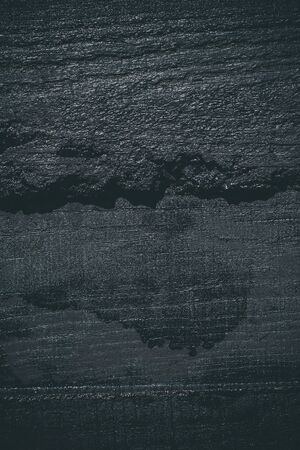 Black resin wall texture with scratches and cracks.の写真素材