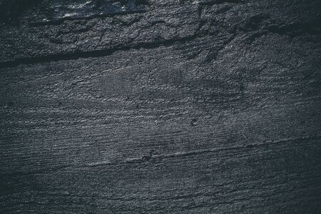 Black resin wall texture with scratches and cracks.の写真素材