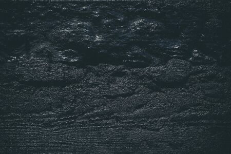 Black resin wall texture with scratches and cracks.の写真素材