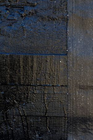 Black resin wall texture with scratches and cracks.の写真素材