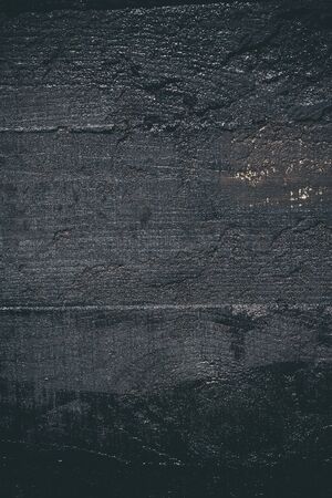 Black resin wall texture with scratches and cracks.の写真素材