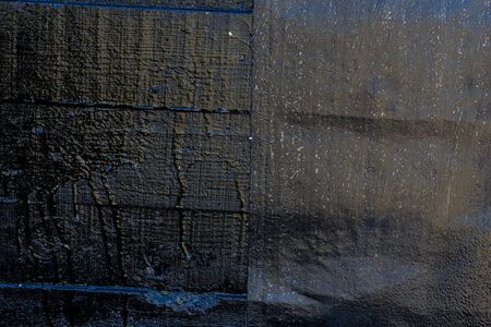 Black resin wall texture with scratches and cracks.の写真素材