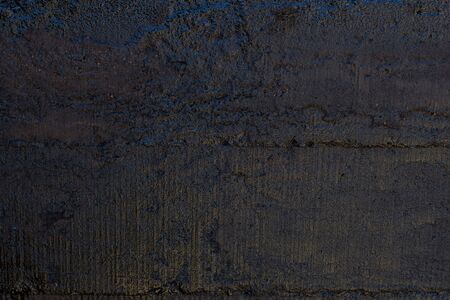 Black resin wall texture with scratches and cracks.の写真素材