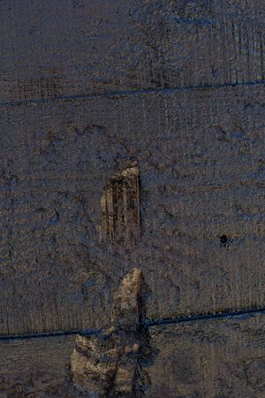 Black resin wall texture with scratches and cracks.の写真素材