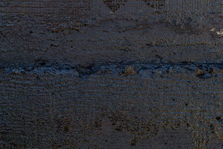 Black resin wall texture with scratches and cracks.の写真素材