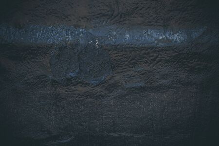 Black resin wall texture with scratches and cracks.