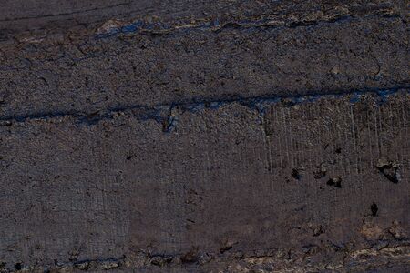Black resin wall texture with scratches and cracks.の写真素材