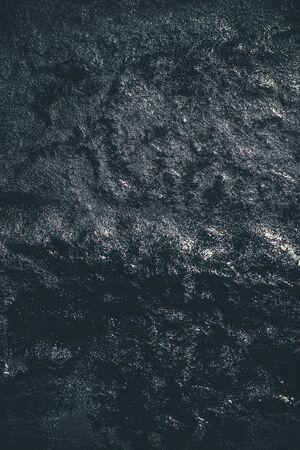Black resin wall texture with scratches and cracks.の写真素材