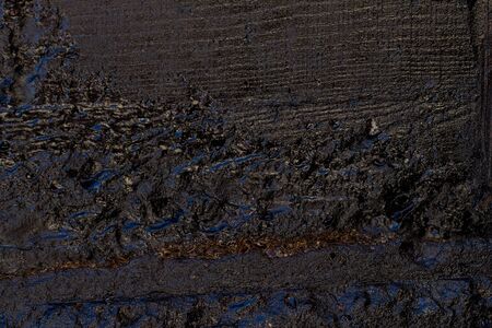 Black resin wall texture with scratches and cracks.の写真素材