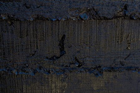 Black resin wall texture with scratches and cracks.