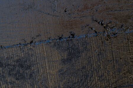 Black resin wall texture with scratches and cracks.の写真素材