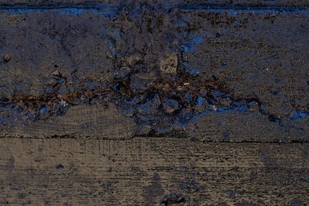 Black resin wall texture with scratches and cracks.