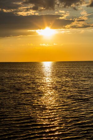Beautiful sunset by the sea in summer in fine weatherの写真素材