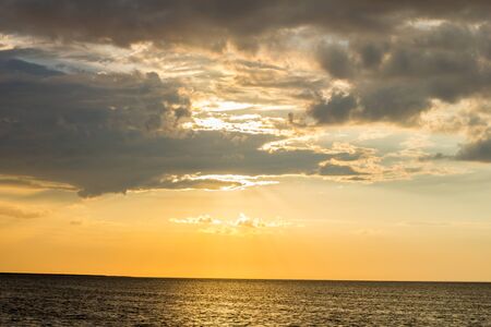 Beautiful sunset by the sea in summer in fine weatherの写真素材