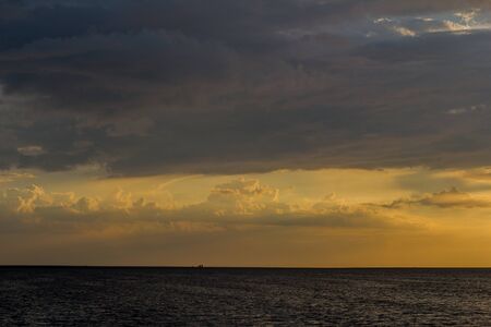 Beautiful sunset by the sea in summer in fine weatherの写真素材
