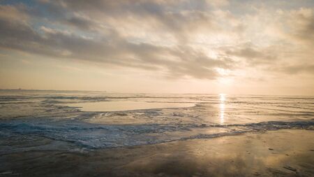 A large number of pieces of ice by the river at sunsetの写真素材