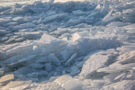 Large pieces of ice by the river in winterの写真素材