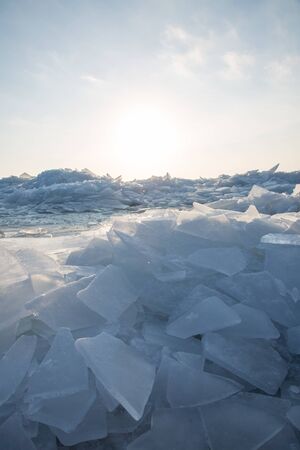 A large number of pieces of ice by the river at sunsetの写真素材