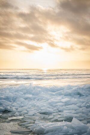 A large number of pieces of ice by the river at sunsetの写真素材