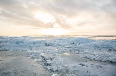 A large number of pieces of ice by the river at sunsetの写真素材
