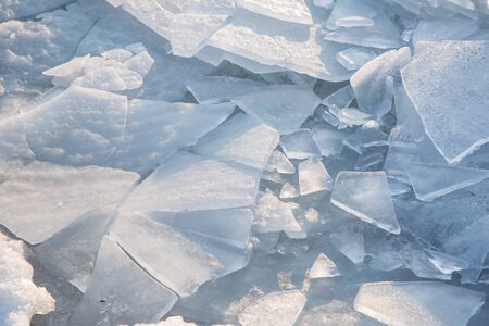 Large pieces of ice by the river in winterの写真素材