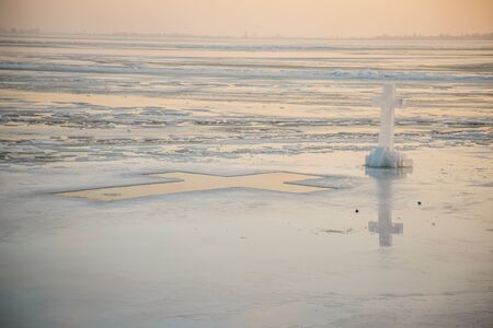 A large number of pieces of ice by the river at sunsetの写真素材