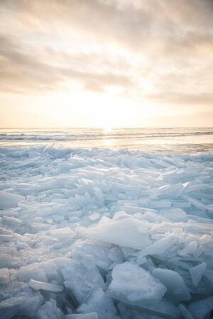 A large number of pieces of ice by the river at sunsetの写真素材