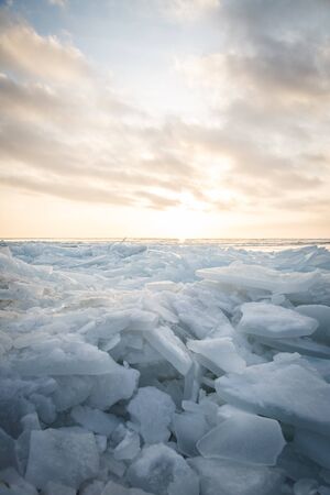 A large number of pieces of ice by the river at sunsetの写真素材