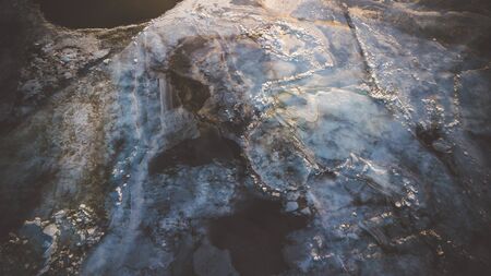 Bid on a frozen river with pieces of ice from a height of flight in the evening