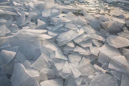 Large pieces of ice by the river in winterの写真素材