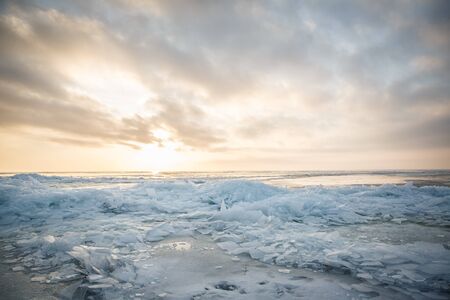 A large number of pieces of ice by the river at sunsetの写真素材