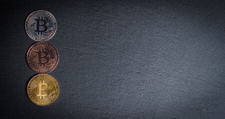 Bitcoins and gold bullion on black background closeの写真素材