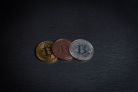 Bitcoins and gold bullion on black background closeの写真素材