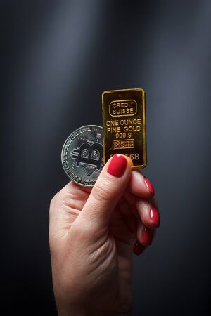 Bitcoins in a girl's hand on a black backgroundの写真素材