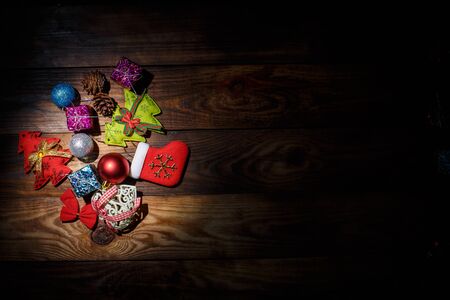 Beautiful Christmas toys on the holiday tree on a wooden vintage tableの写真素材