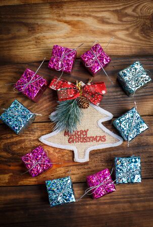 Beautiful Christmas toys on the holiday tree on a wooden vintage tableの写真素材