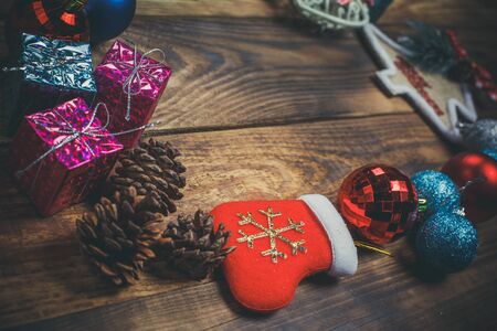 Beautiful Christmas toys on the holiday tree on a wooden vintage tableの写真素材