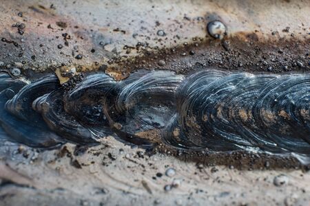 Welding seam on metal close on metal constructionの写真素材