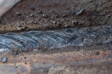 Welding seam on metal close on metal constructionの写真素材