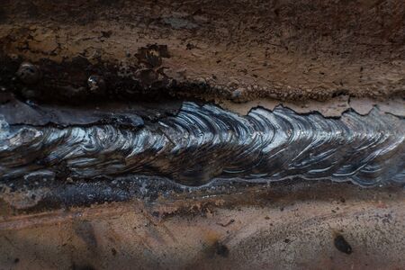Welding seam on metal close on metal constructionの写真素材