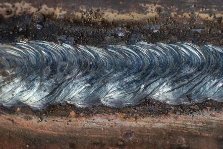 Welding seam on metal close on metal constructionの写真素材
