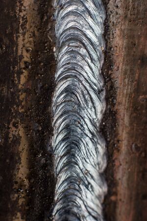Welding seam on metal close on metal constructionの写真素材