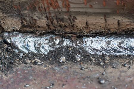 Welding seam on metal close on metal constructionの写真素材
