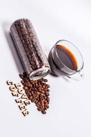 Coffee beans in a plastic jar on a white backgroundの写真素材