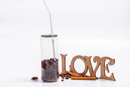 Coffee beans in a plastic jar on a white backgroundの写真素材