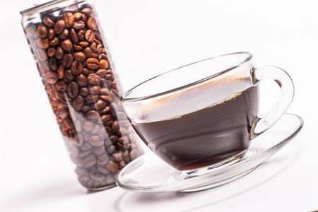 Coffee beans in a plastic jar on a white backgroundの写真素材