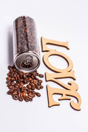 Coffee beans in a plastic jar on a white backgroundの写真素材